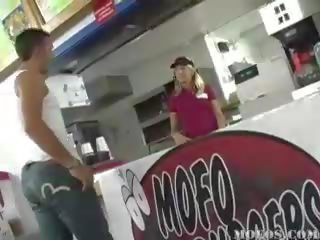 Sexy fast food worker gets down on her knees to blow two guys